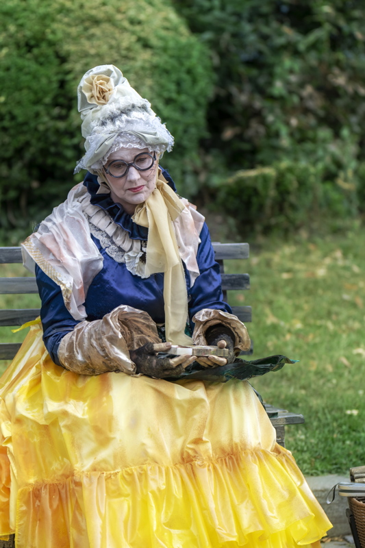 8 - A performer dressed as a living statue in a period costume, likely for a street theater festival in Bucharest